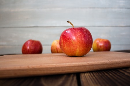 the apples on the wooden boardの写真素材