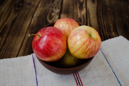 the apples on the wooden boardの写真素材