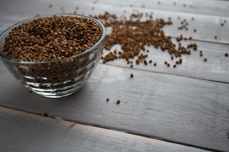 the buckwheat porridge in bowl and on wooden boardの写真素材