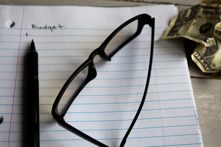 notebook glasses pen dollar budgetの写真素材