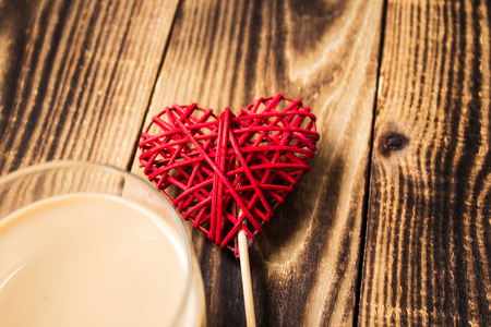 a cup of coffee with milk and handmade heartの写真素材