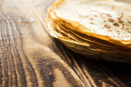 a pile of crepe, pancakes on wooden backgroundの写真素材