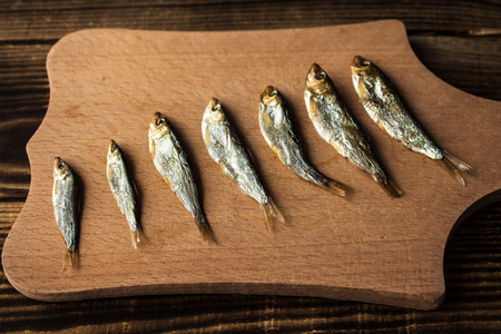 a little smoked sprats on wooden backgroundの写真素材