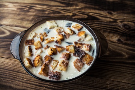 the bowl of white soup with croutonsの写真素材