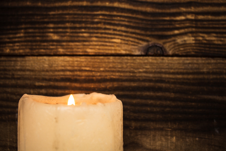 a candle light on the wooden backgroundの写真素材