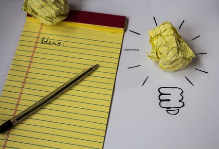 bright idea drawn paper pen notebook wood backgroundの写真素材