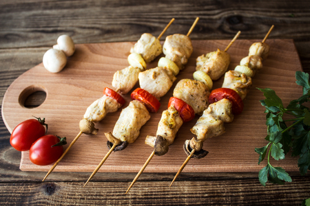 chicken shish kebab with tomato and mushroom barbecue on woodの写真素材