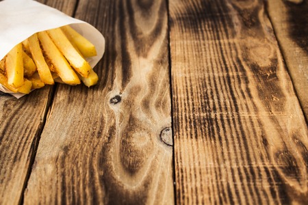 a homemade french fries on wooden backgroundの写真素材