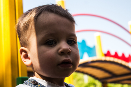 baby boy playing on the playground summer morningの写真素材