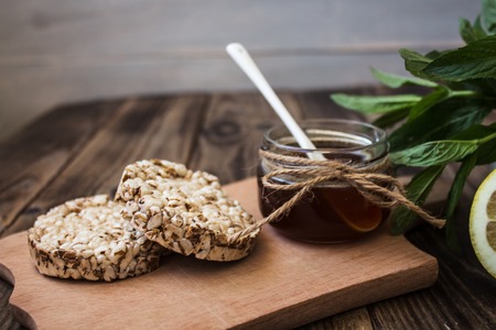 jar of honey with rice cookies on wooden backgroundの写真素材