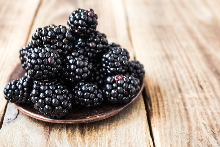 the ripe blackberries on a wooden backgroundの写真素材