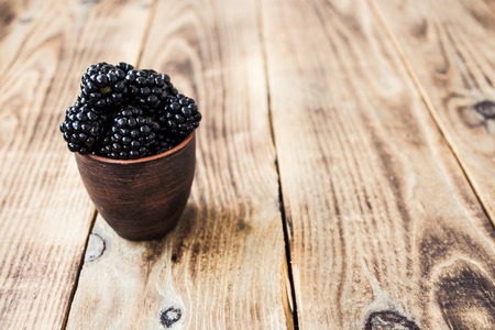 the ripe blackberries on a wooden backgroundの写真素材