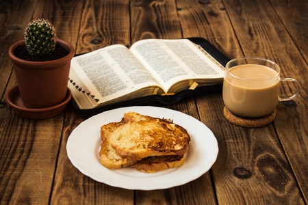 Bible and coffee French toasts cactus breakfast wooden backgroundの写真素材