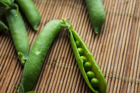 a ripe green peas on wooden backgroundの写真素材