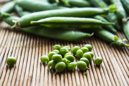 a ripe green peas on wooden backgroundの写真素材