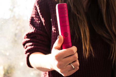 a woman holding bible inspirationの写真素材