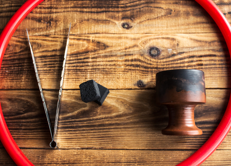 a charcoal bowl hose for shisha on a wooden backgroundの写真素材