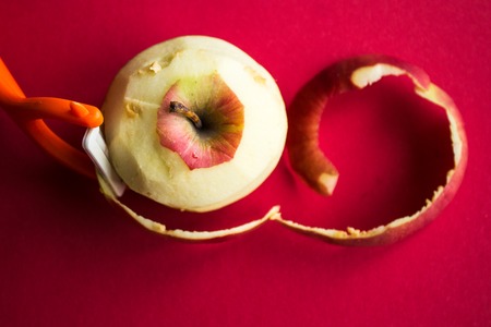 a cleared apple on a red backgroundの写真素材