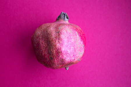 a ripe pomegranate on a red backgroundの写真素材