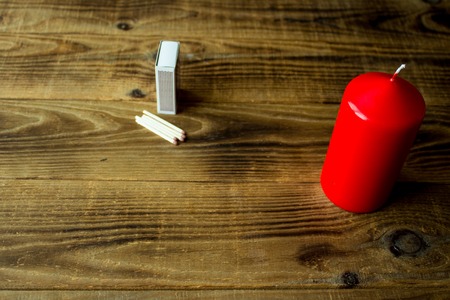 a candle and matches on a wooden backgroundの写真素材