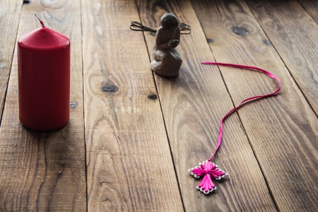 angel and a cross and candle on wooden backgroundの写真素材