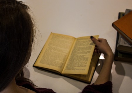 a beautiful girl is reading a book
