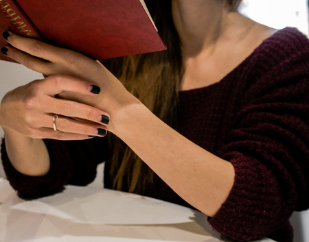 a beautiful girl is reading a bookの写真素材
