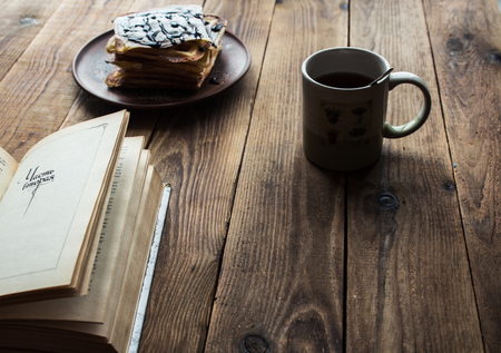 a cup of tea and a pile of wafers on wooden backgroundの写真素材