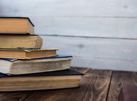pile of old books on wooden backgroundの写真素材
