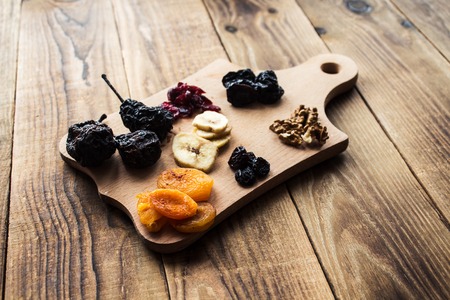 a prunes and dried apricots raisins cranberries walnutsの写真素材