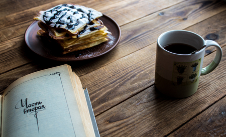 a cup of tea and a pile of wafers on wooden backgroundの写真素材