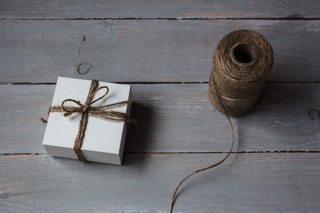 a gift box tied with a rope on wooden backgroundの写真素材