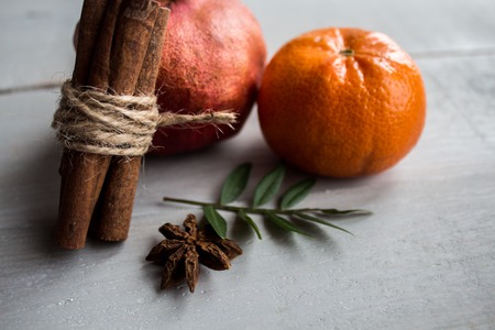pomegranate mandarin cinnamon and onyx on the wooden backgroundの写真素材