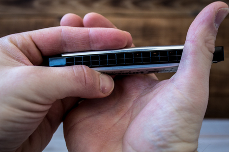 a harmonica in the hands of a man