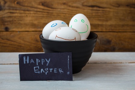 easter eggs in a plate on wooden background