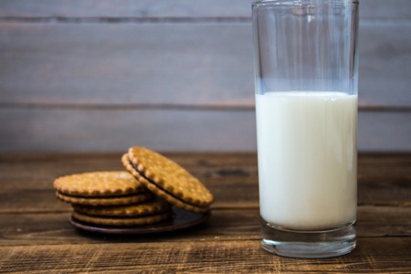 a cookies and milk on wooden backgroundの写真素材