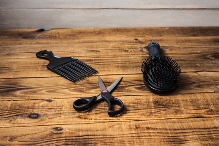 a combs and scissors on wooden backgroundの写真素材