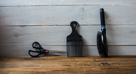 a combs and scissors on wooden backgroundの写真素材