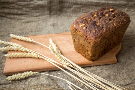 a bread with spikelets on sackcloth backgroundの写真素材
