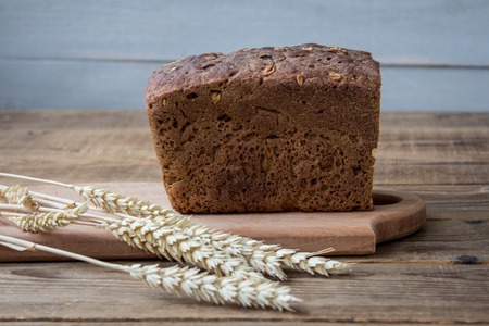 a bread with spikelets on sackcloth backgroundの写真素材