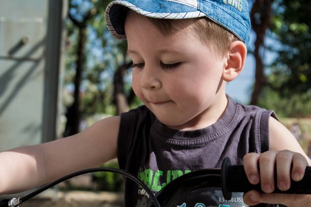 litlle boy on a bicycle outdoorの写真素材