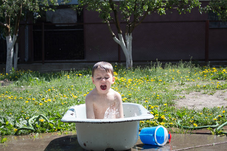boy is playing in the bathroom outdoorsの写真素材
