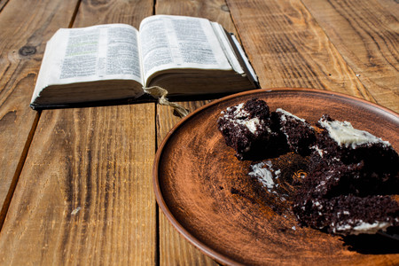 a piece of chocolate cake on a plate and bookの写真素材
