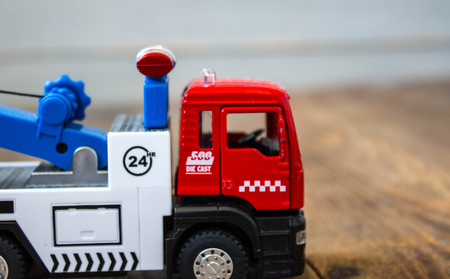 tow truck childrens toys on wooden backgroundの写真素材