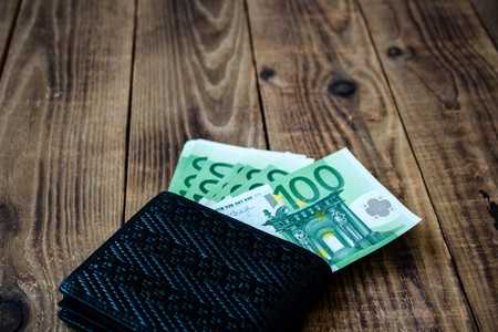 wallet with money on a wooden backgroundの写真素材
