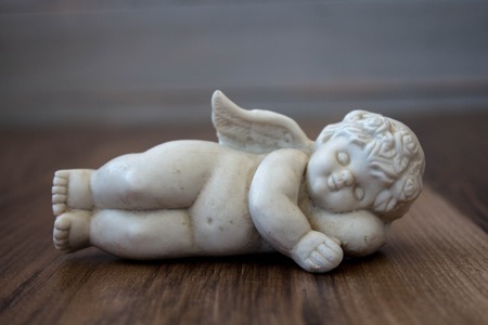 litle angel on a wooden backgroundの写真素材