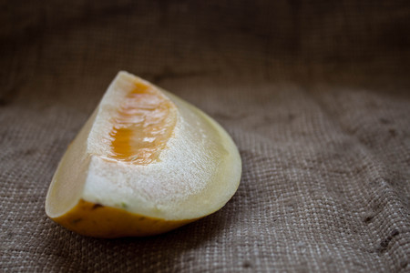 a ripe juicy melon sliced in half in a sacking backgroundの写真素材