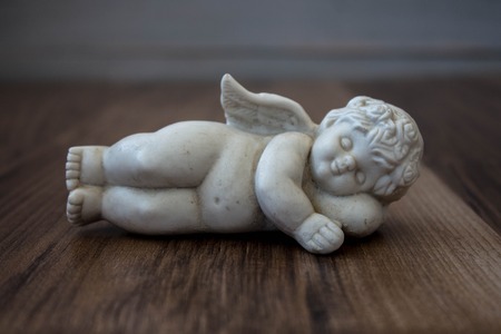 angel statue on a wooden backgroundの写真素材