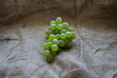 bunch of ripe grapes against a burlapの写真素材