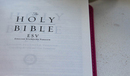 open holy bible on a white backgroundの写真素材